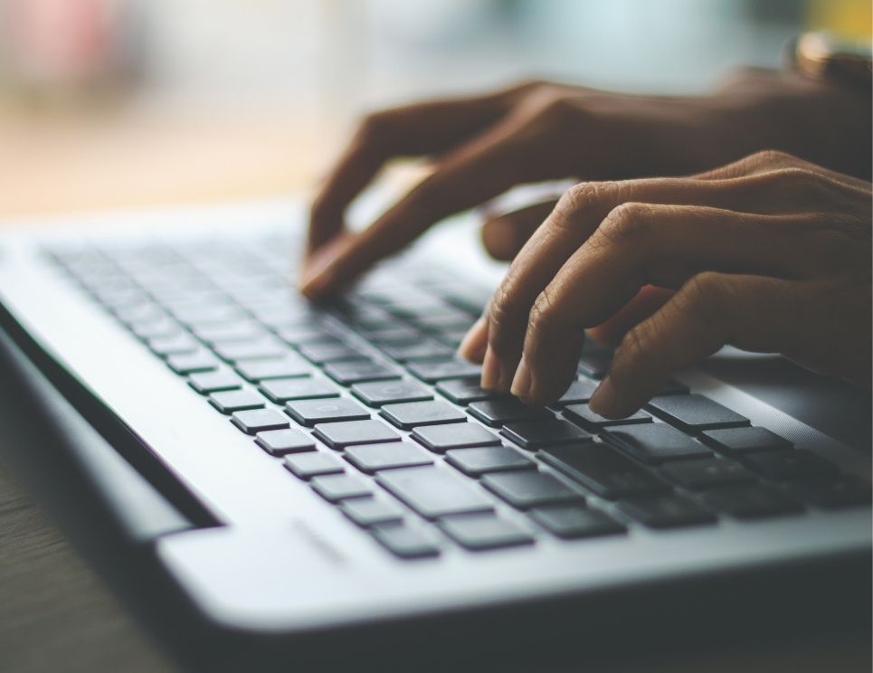 Hands typing on a keyboard